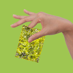 Hand holding crispy avocado oil seaweed between fingers| Morish Snacks