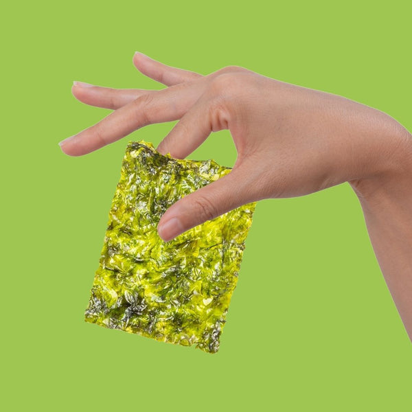 Hand holding crispy avocado oil seaweed | Morish Snacks