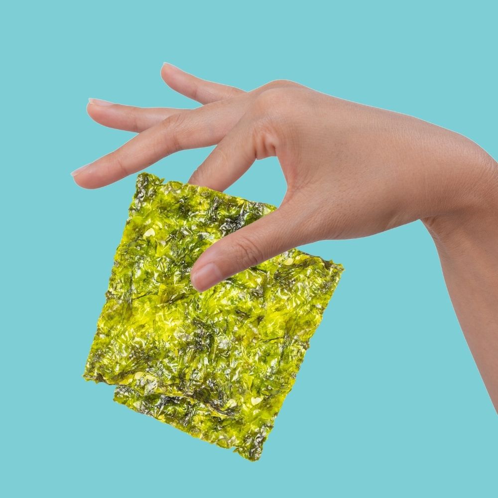 Fingers holding 2 seaweed sheets | Morish Snacks
